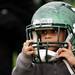 Georgia resident Nicolas Kashama, three, wears a football helmet on Sunday, April 14. Defensive end Kalonji Kashama is his uncle. AnnArbor.com I Daniel Brenner